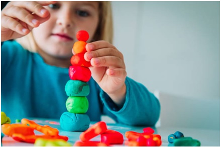 Kids making strategies and playing with clay